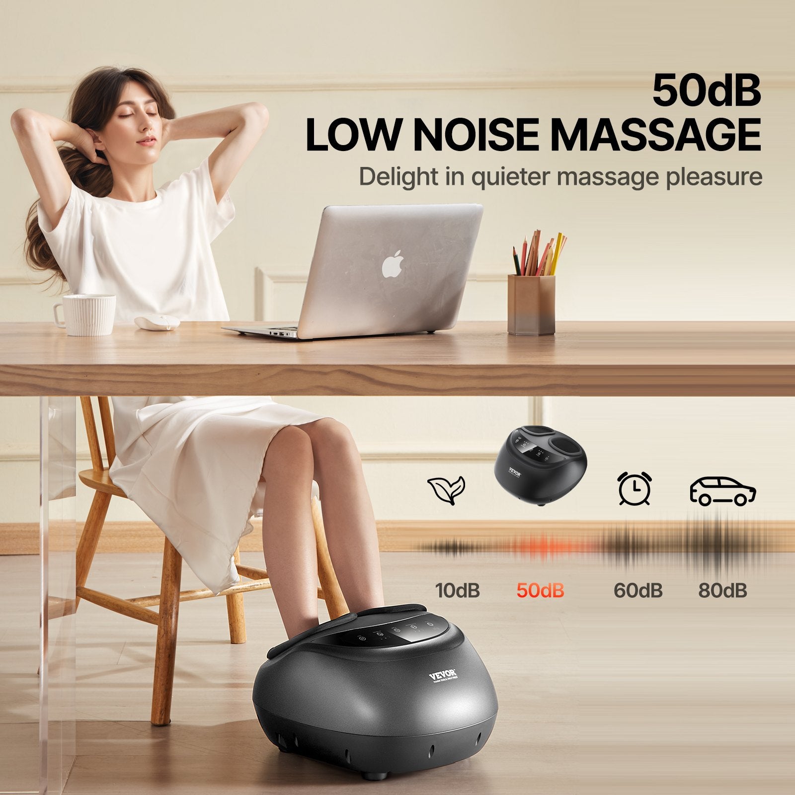 Black foot massager shown in use under a table with feet resting on the unit