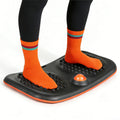 Orange and black balance board with grippy nub footplate and orange dome