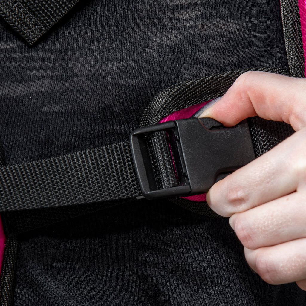 Close-up of black buckle and strap on pink weighted vest for adjusting fit
