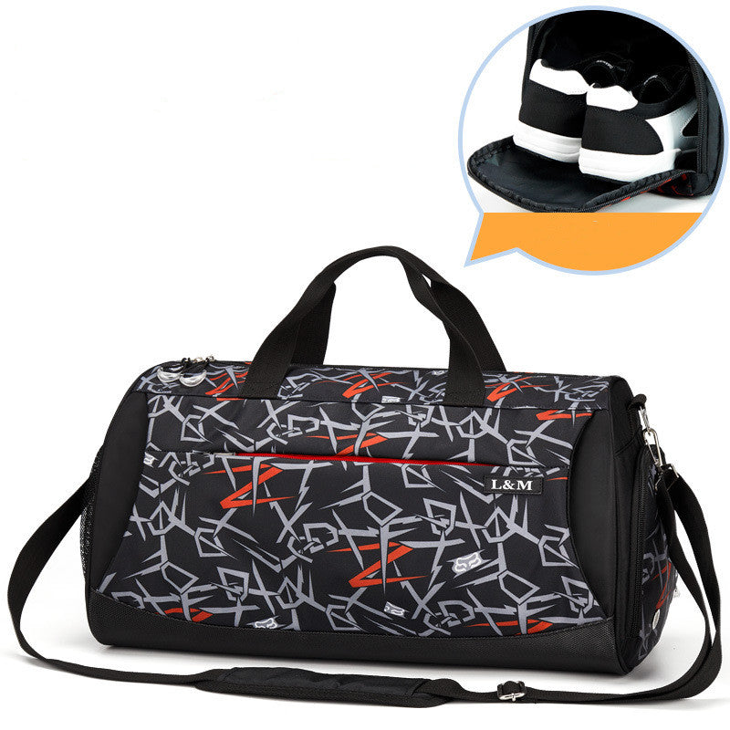 Black graphic gym duffel bag with top handles, shoulder strap, and side shoe pocket with sneakers