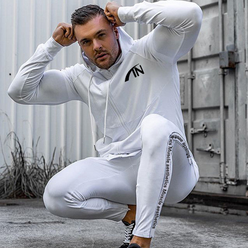 White men’s zip-up hoodie and jogger tracksuit set with cuffed sleeves and tapered legs.