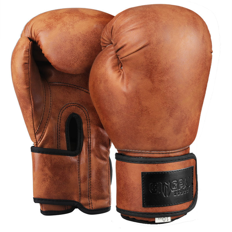 Brown vintage boxing gloves with black wrist strap and thumb guard, pair front view