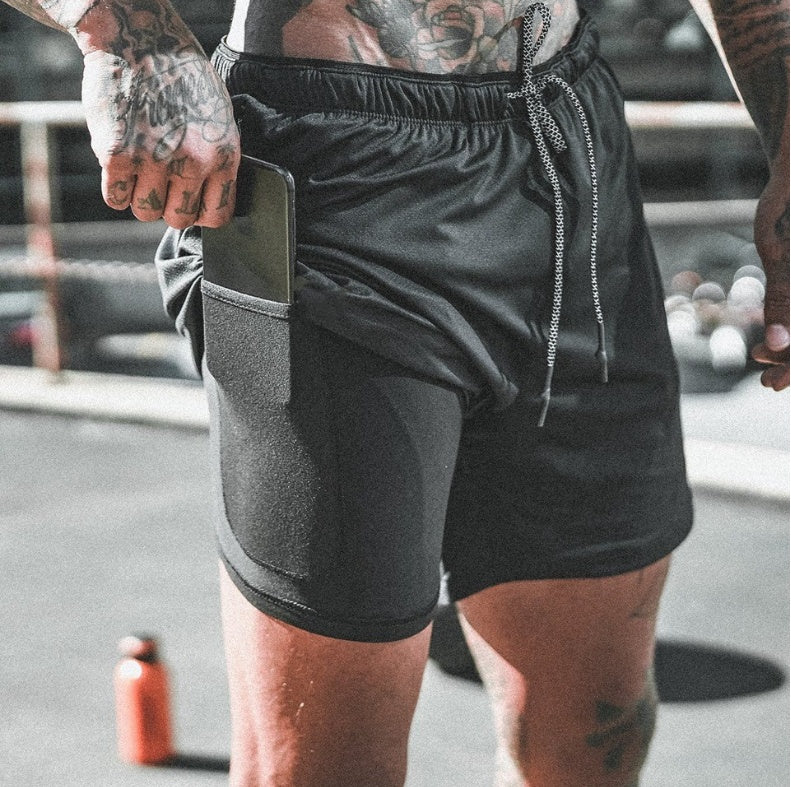 Black athletic shorts with side phone pocket, drawstring waist, and zip pull cords