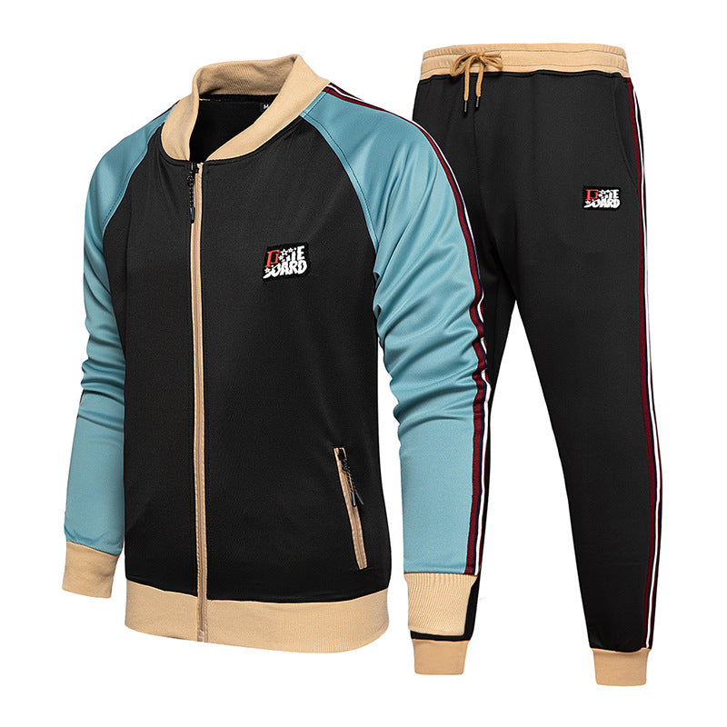 Colorblock zip-up tracksuit: black jacket with turquoise sleeves, beige trim, black joggers