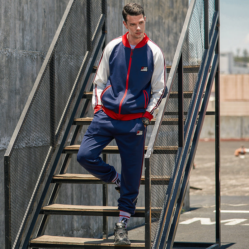 Men's colorblock tracksuit in navy and white with red accents, zip jacket and joggers