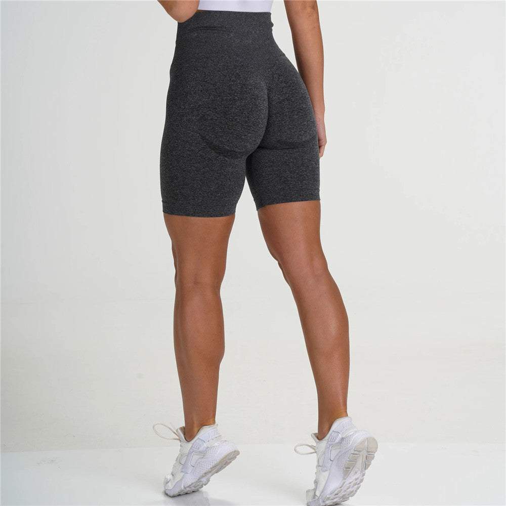 Women’s high-waist push-up yoga shorts in dark grey heather, side view on model
