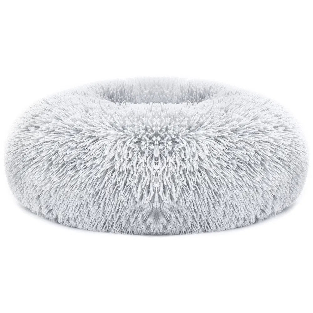 Light gray fuzzy oval pet bed with thick shag fleece and ruffled center tuft