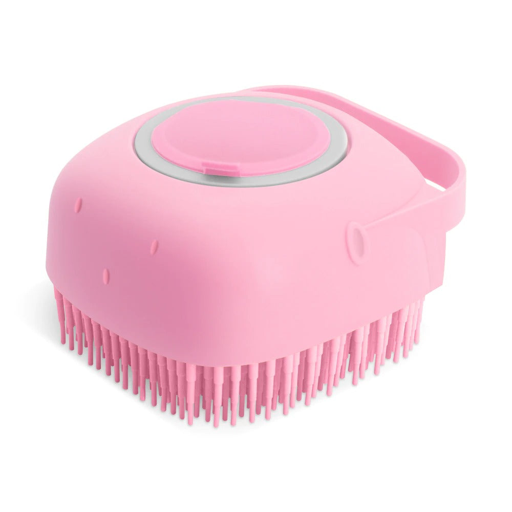 Pink silicone pet bath brush with dense massage bristles and circular flip-top dispenser