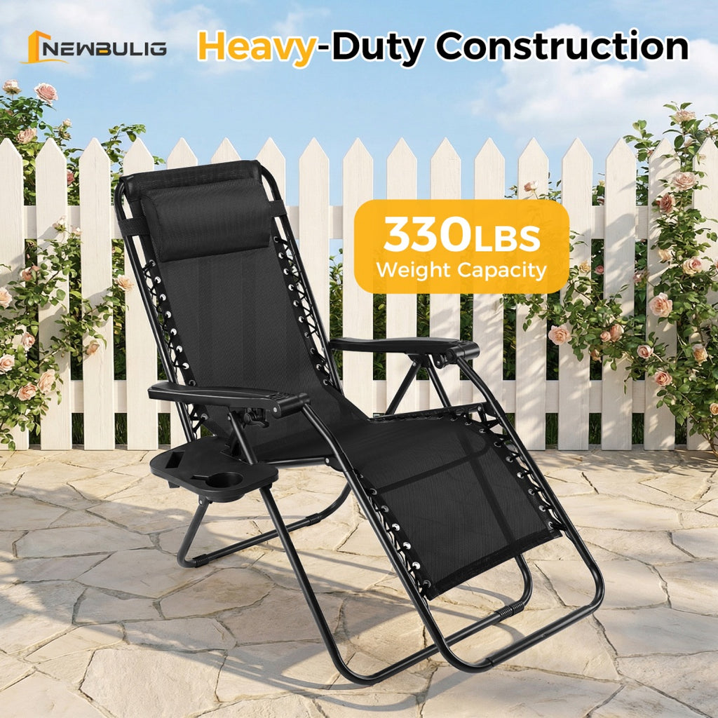 Black folding patio lounge recliner with head pillow and side tray attachment, reclining.