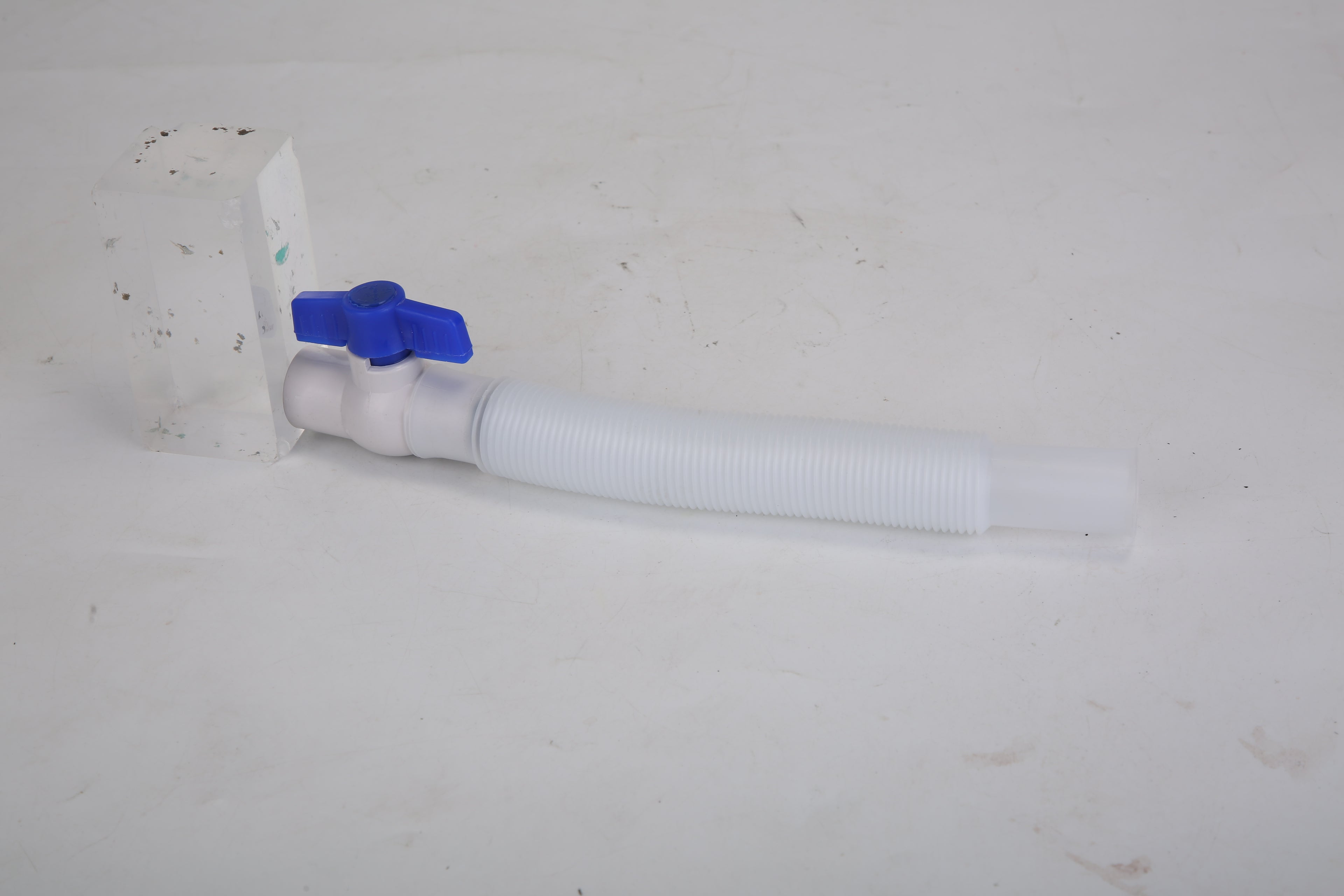 Cold plunge tub water drain valve with white hose and blue shutoff fitting