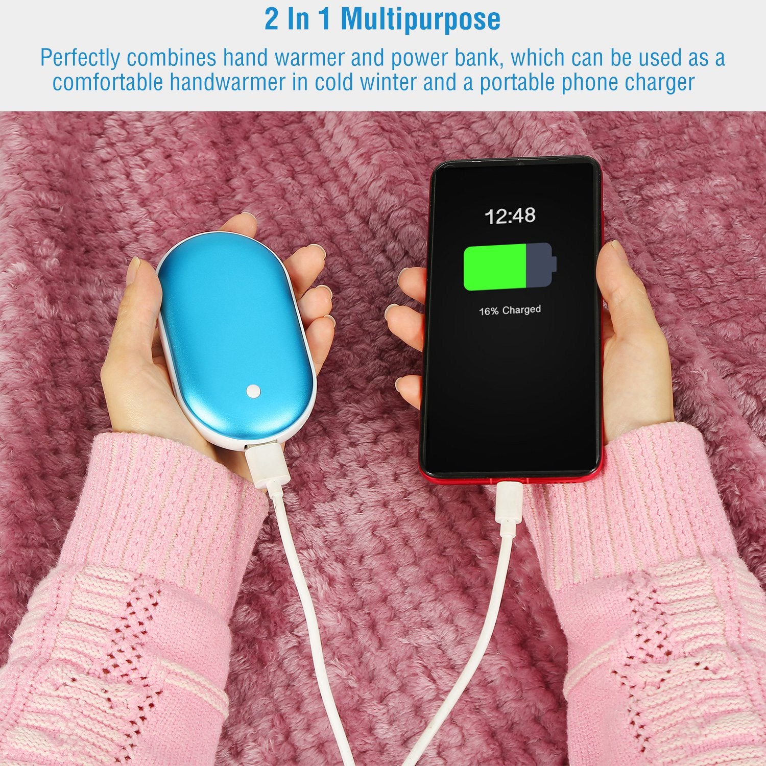 Hand warmer and power bank, blue oval held while charging a smartphone with cords.