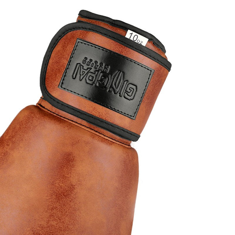 Orange-brown boxing glove cuff with black logo patch and 10oz label, close-up