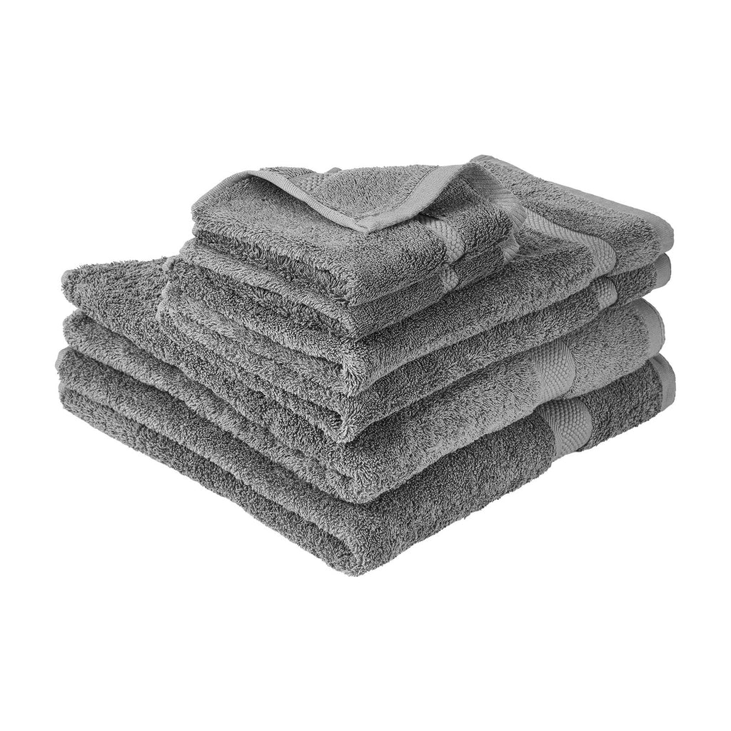 Stacked grey towels with soft terry loops, folded edges and visible seams