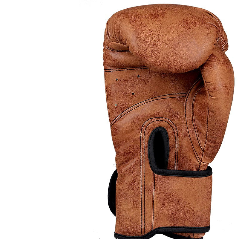 Tan-brown vintage boxing glove with black wrist strap, side view with oval knuckle pad