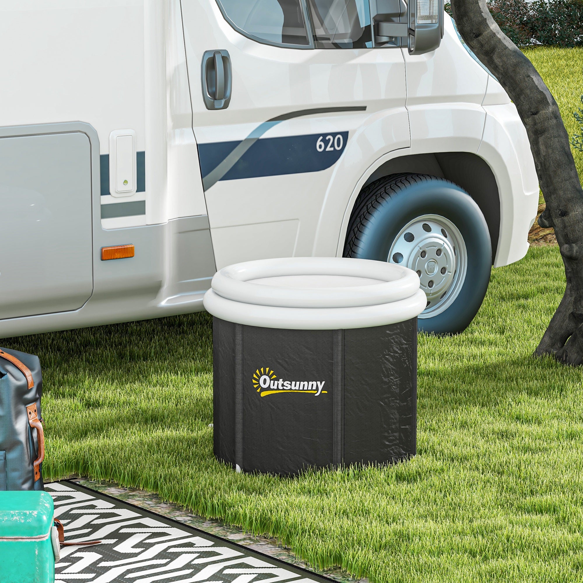 Black portable ice bath tub with white inflatable thermo lid on grass