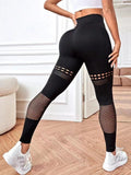 Women’s black seamless yoga leggings with mesh cutout panels on the calves and thighs