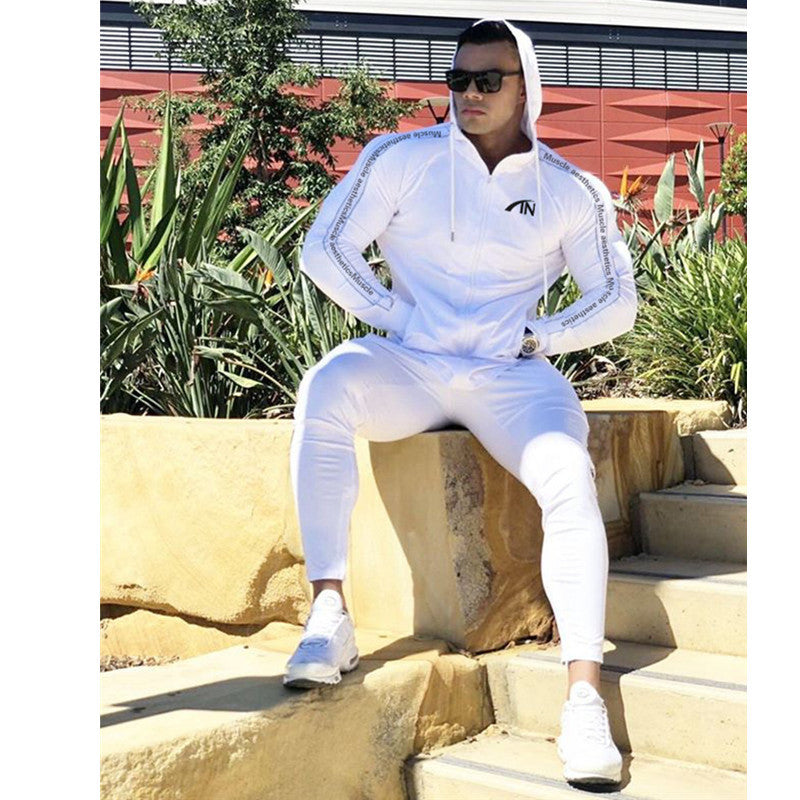 White men’s zip-up hoodie and jogger tracksuit set with striped sleeve and pant details.