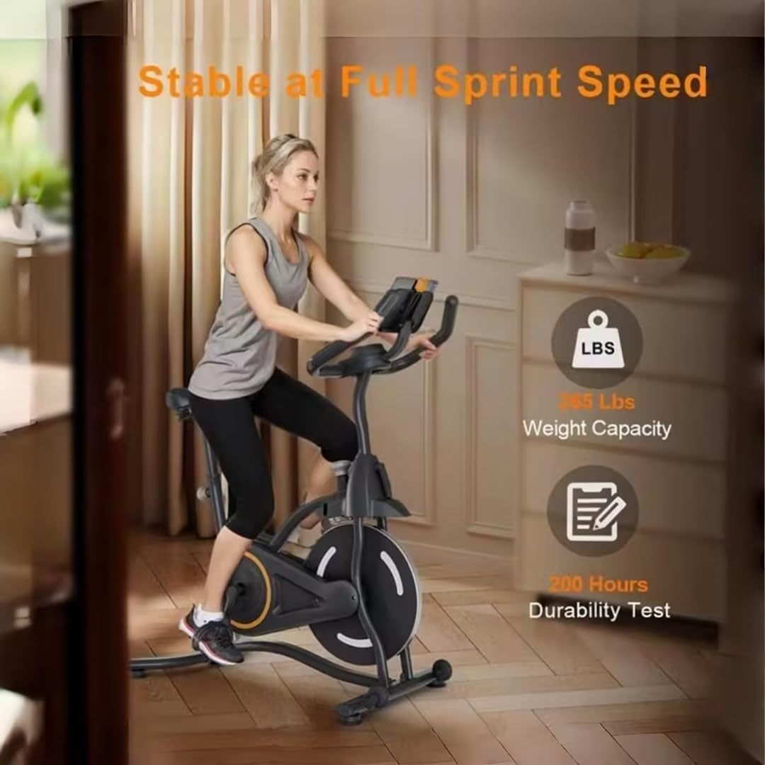 Black magnetic spin bike with large flywheel and adjustable handlebars, used for indoor cycling.