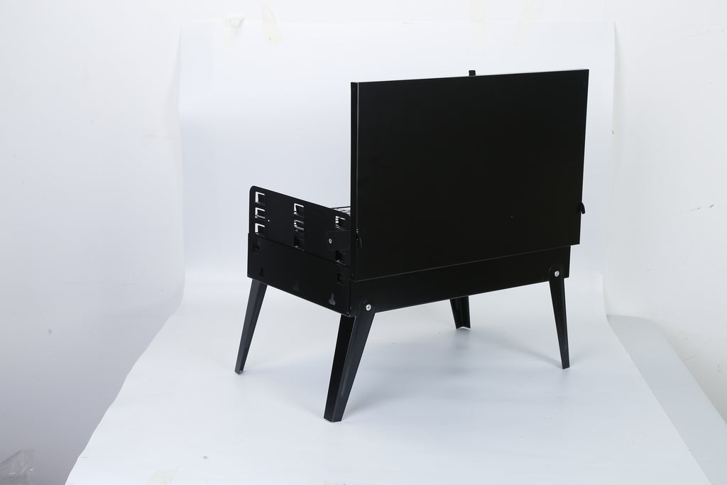 Black portable BBQ grill with lid closed, folding legs and front latch handle
