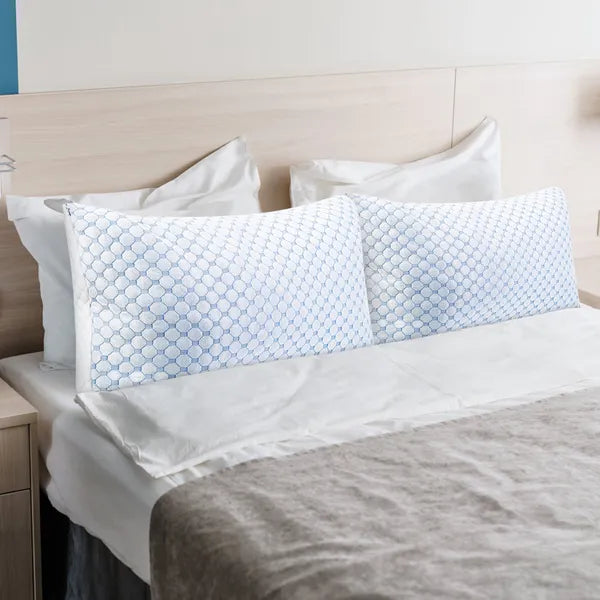 Cooling gel memory foam pillows with blue hex-pattern covers on bed