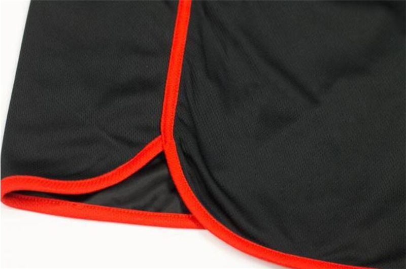 Men's quick-dry mesh fitness shorts, black with bright red side piping trim
