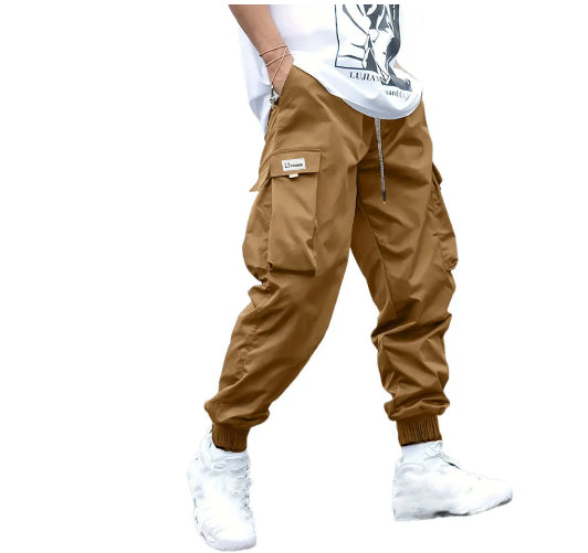 Tan cargo jogger pants with drawstring tie and multiple front utility pockets