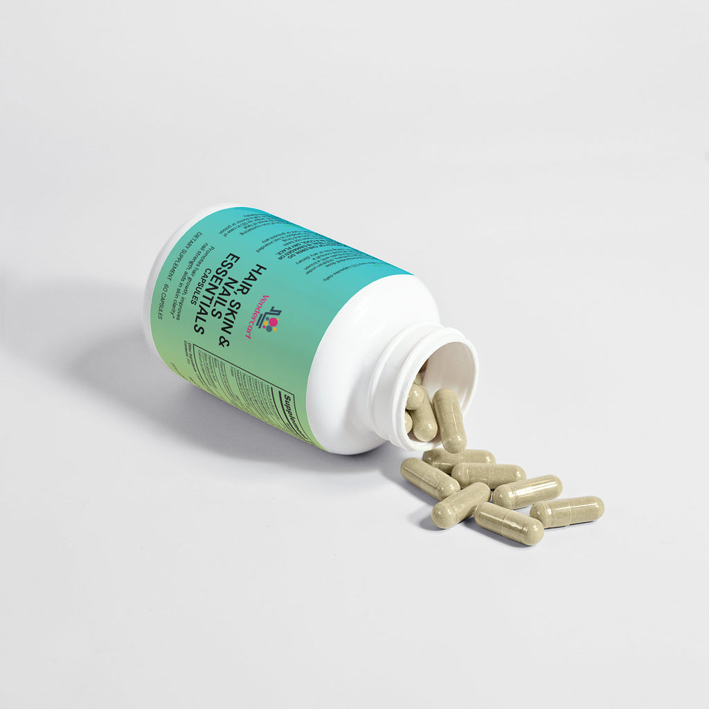 Hair Skin & Nails Essentials bottle with beige softgels spilling from the opening