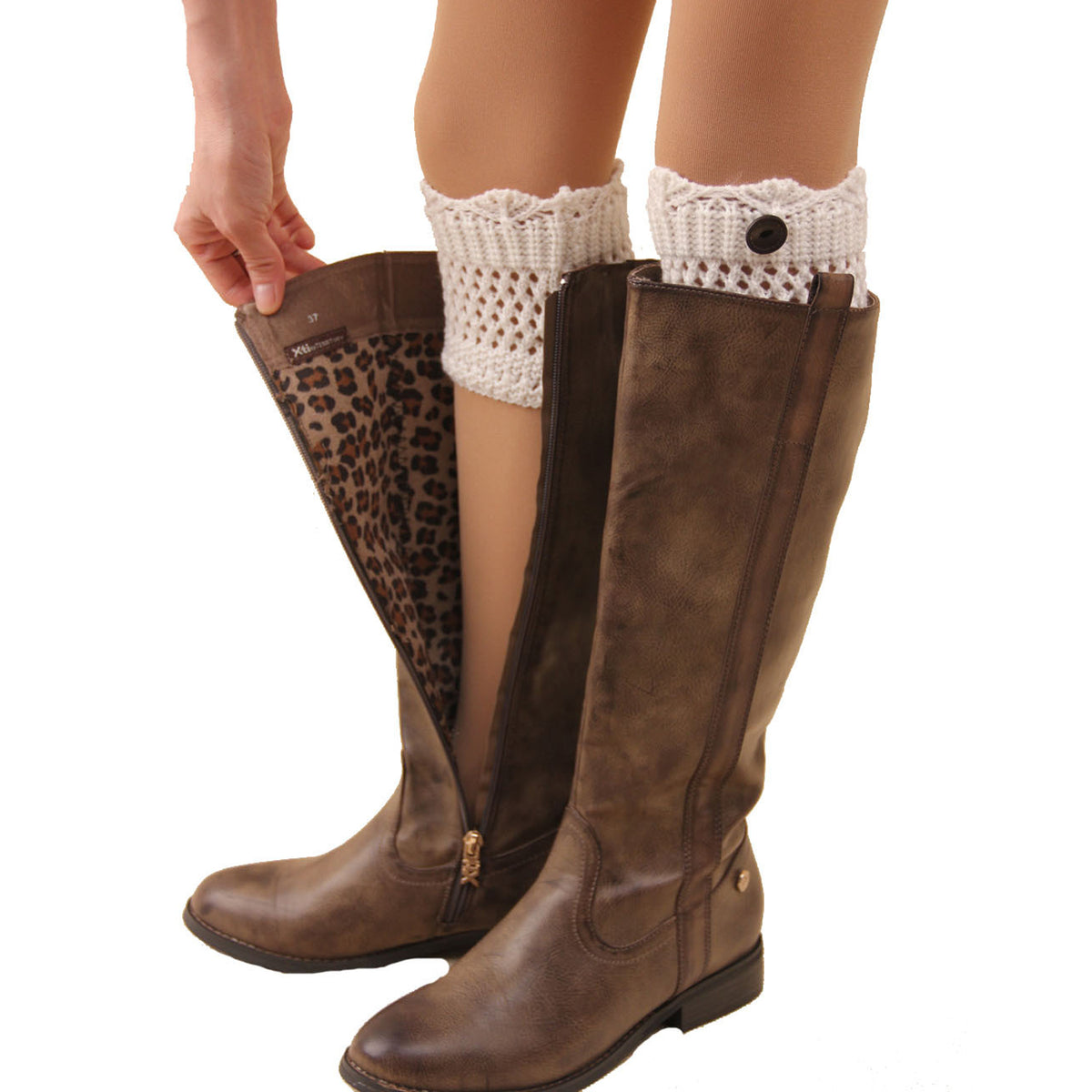 White crochet leg warmers with round metal button, worn over brown boots