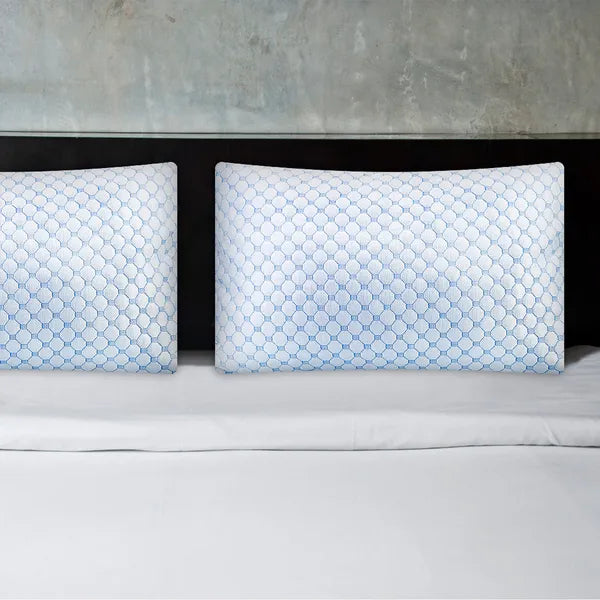 Cooling gel memory foam pillow set with blue hex-pattern covers on bed
