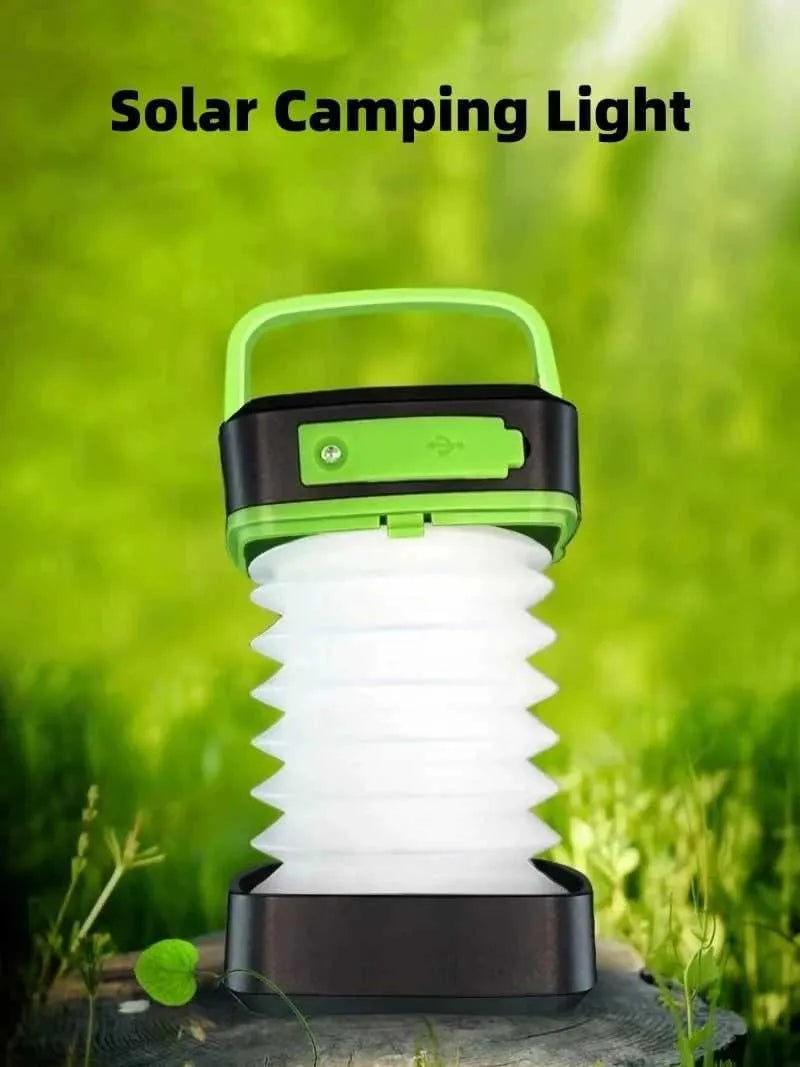 Solar camping lantern with green top handle, black base, and white accordion lamp light