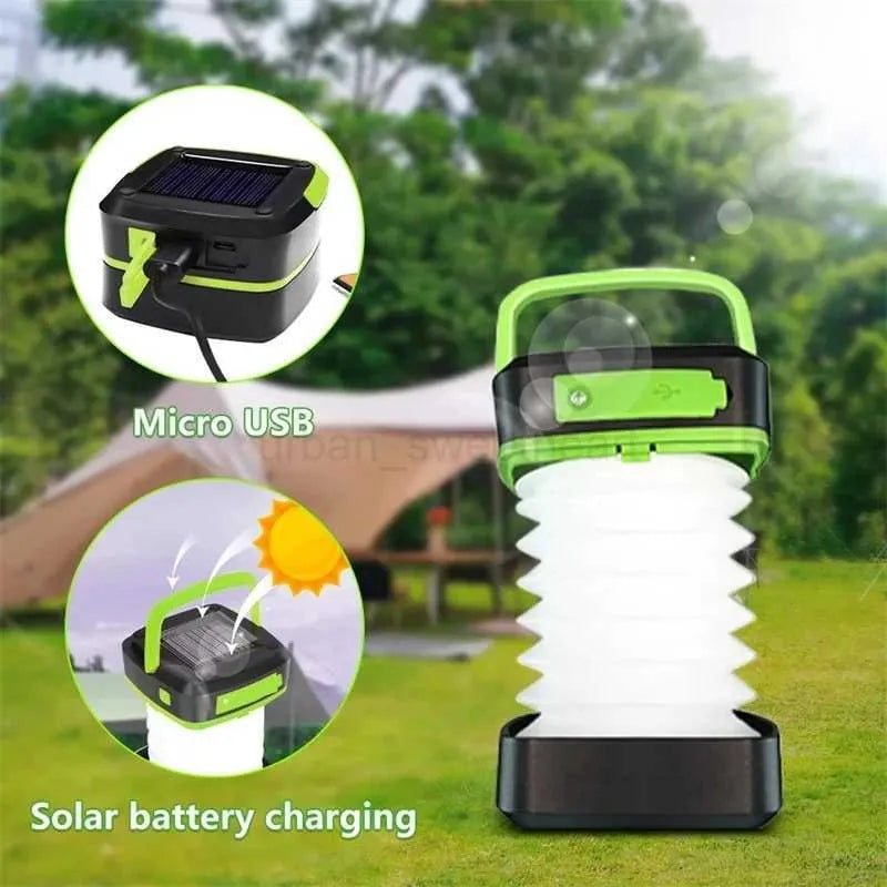 Solar camping lantern outdoors, green handle, white accordion light, with micro USB charging inset