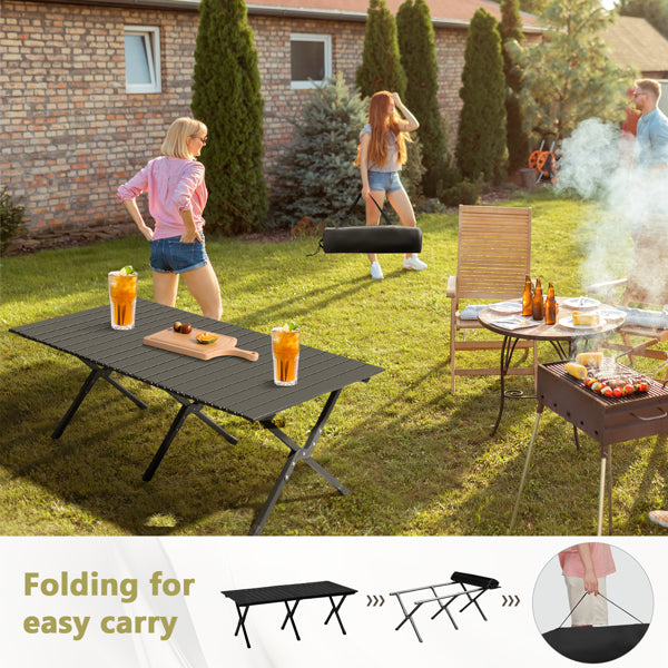 Black foldable outdoor table in yard with drinks on the tabletop