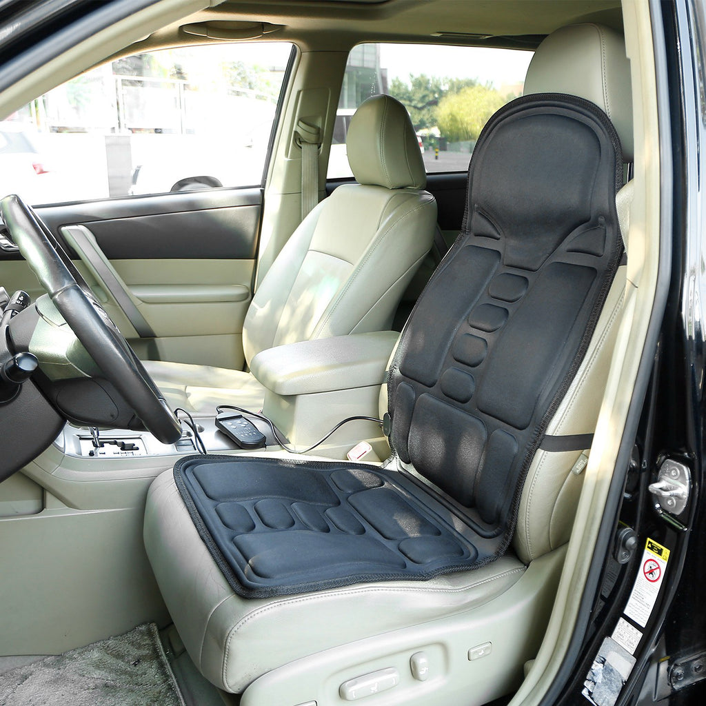 Black seat massage cushion with built-in vibration pads on a car seat
