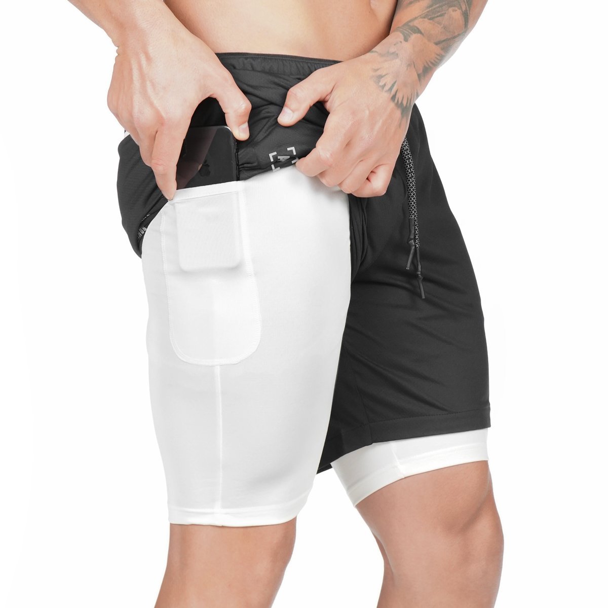 Black training shorts with large front phone pocket, elastic waistband, and drawstring