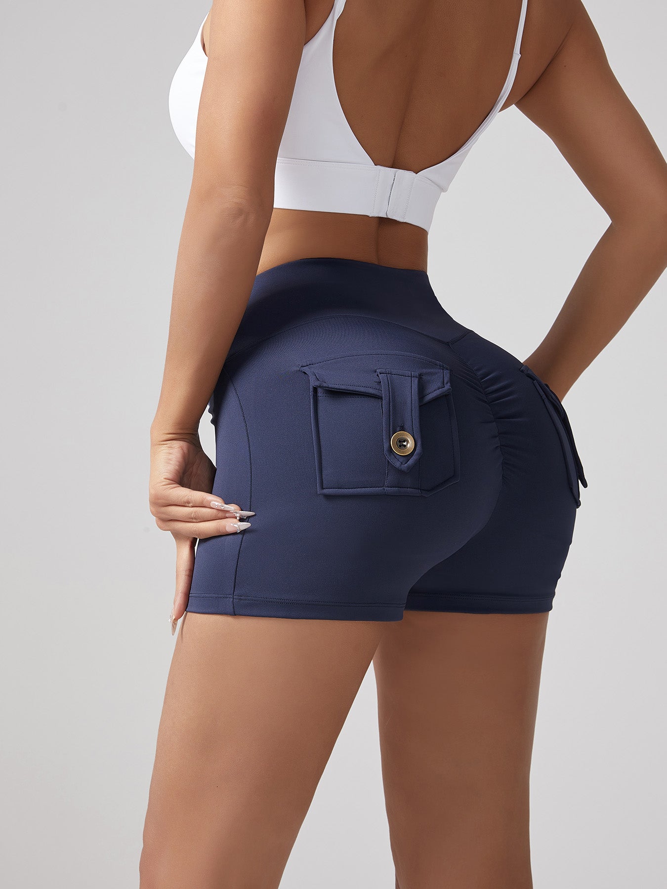 Navy blue running shorts with back pocket and gold button, hip-lifting seam lines