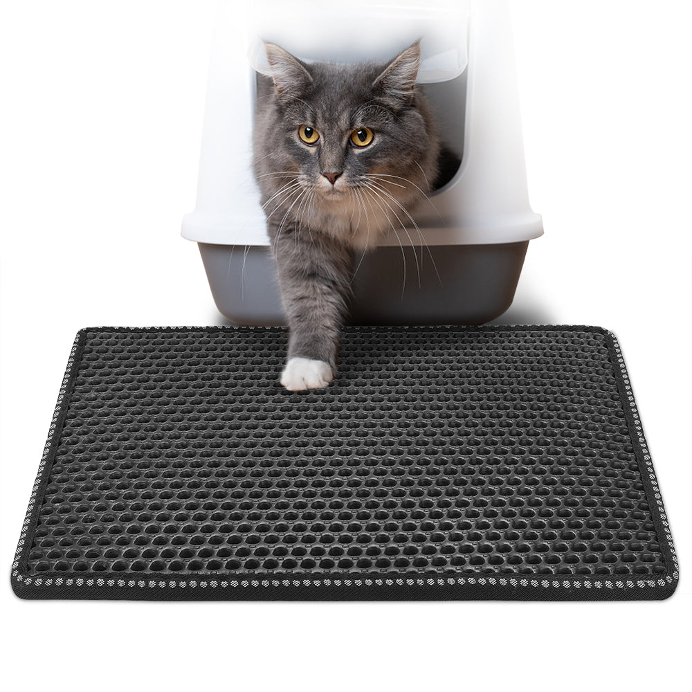 Black cat litter mat with raised hexagonal nubs and splash-guard border