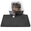 Black cat litter mat with raised hexagonal nubs and splash-guard border