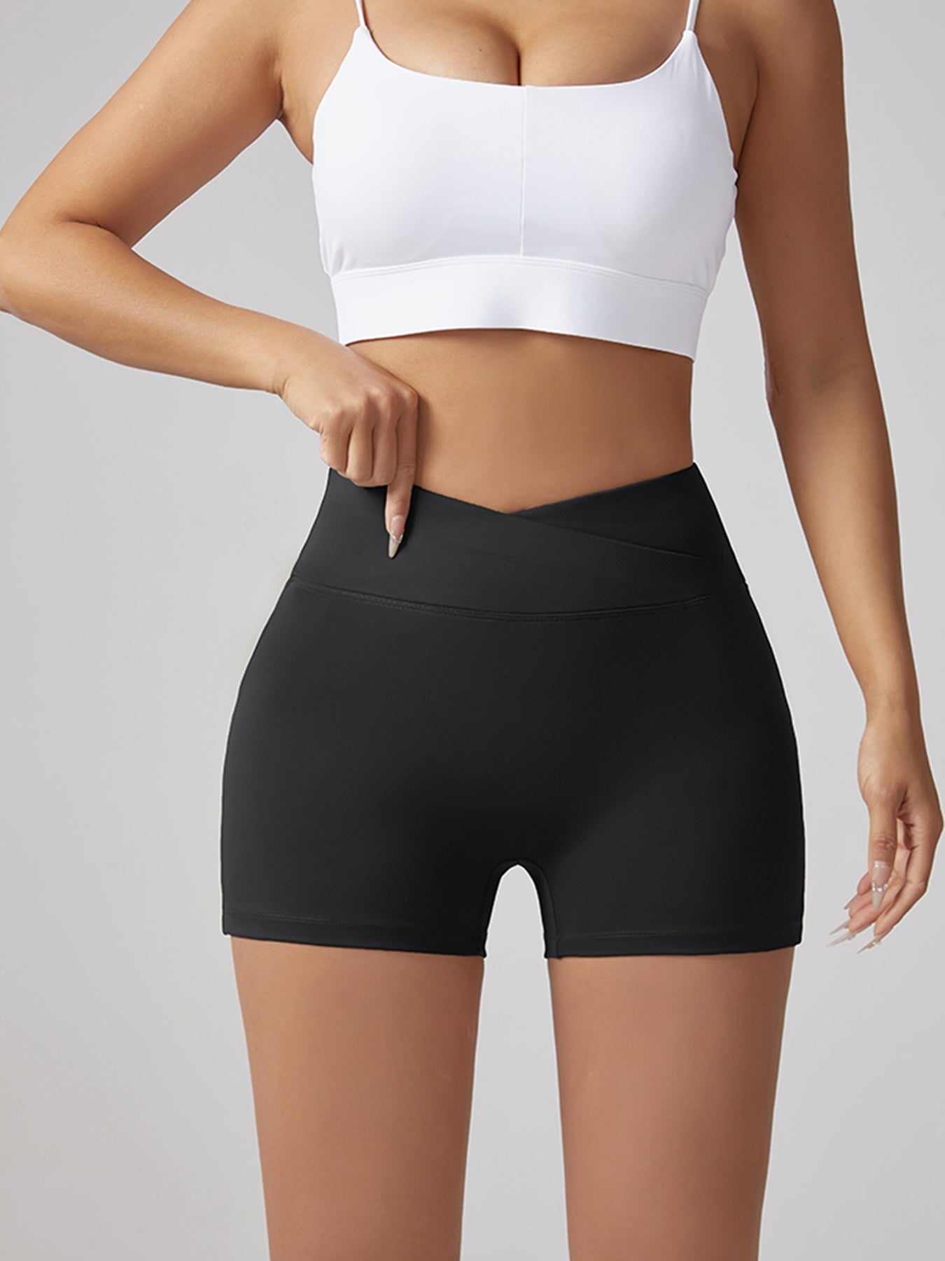 Black V-waist running shorts with hip-lifting fit, smooth flat front and leg-length hem