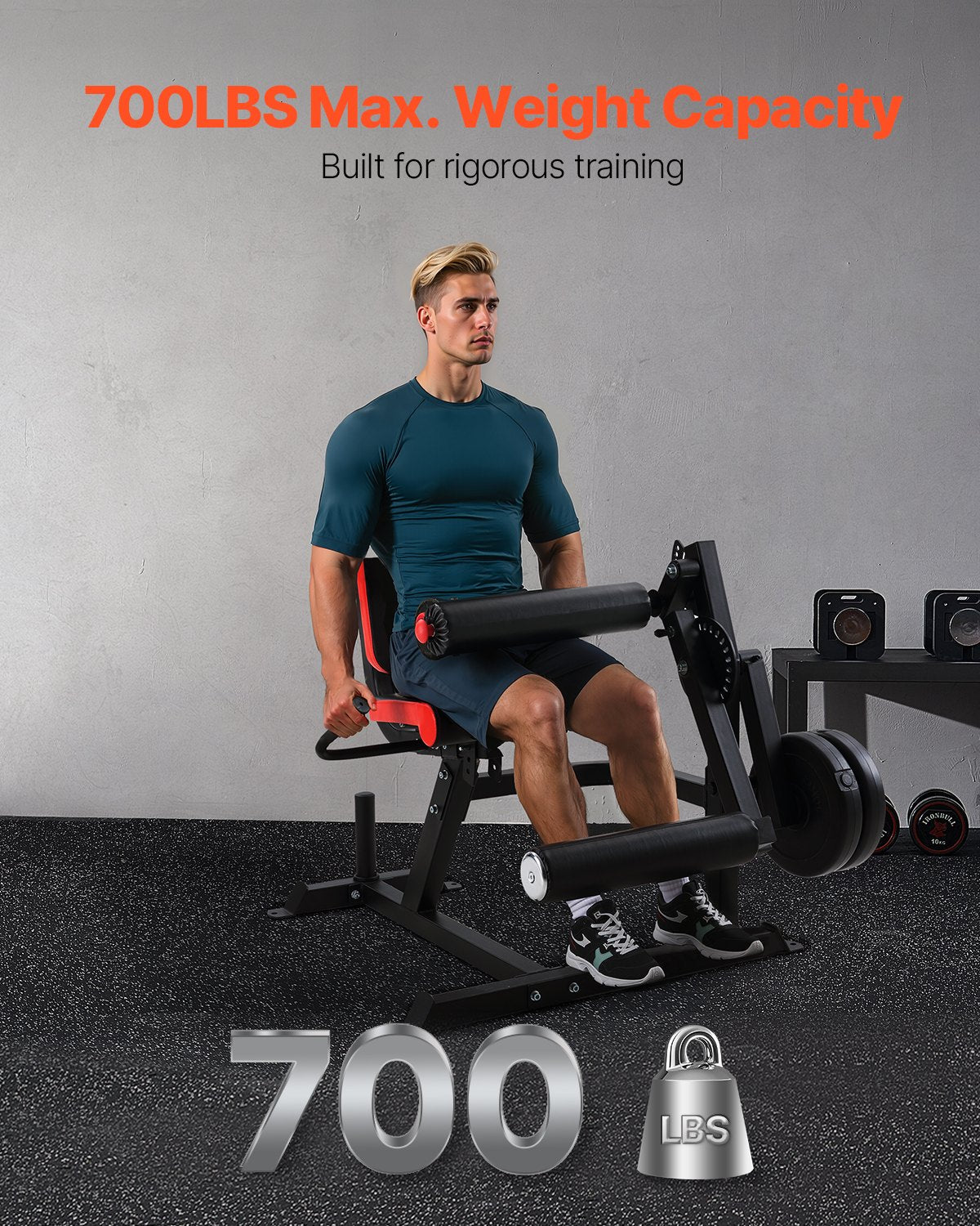 Leg extension and curl machine with padded black-and-red leg station for seated training