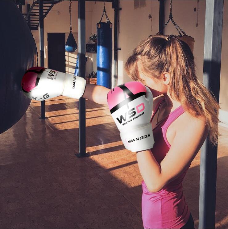 Pink and white boxing gloves with padded knuckles and wrist wrap for training