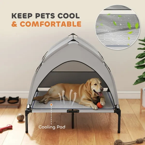 Grey dog cot with removable canopy and cooling pad, dog lying inside