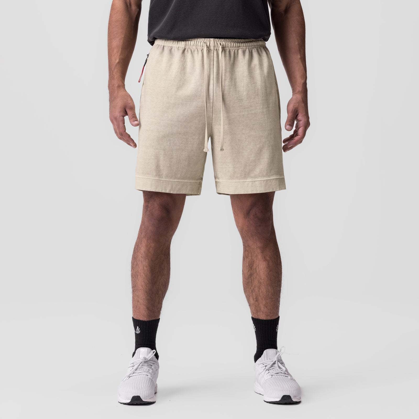 Beige quick-dry shorts with elastic waistband and drawstring; side zip pocket