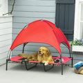 Golden retriever lounging on red elevated dog cot with mesh base and canopy