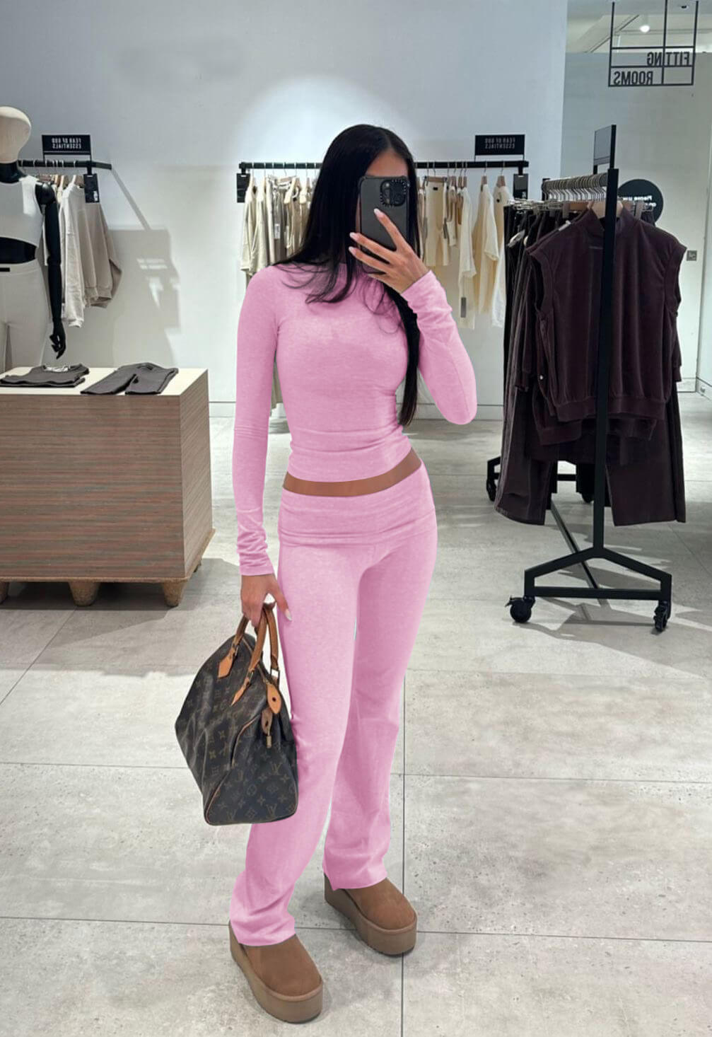 Pink long-sleeve fitted crop top and flared pants set with matching waist seam