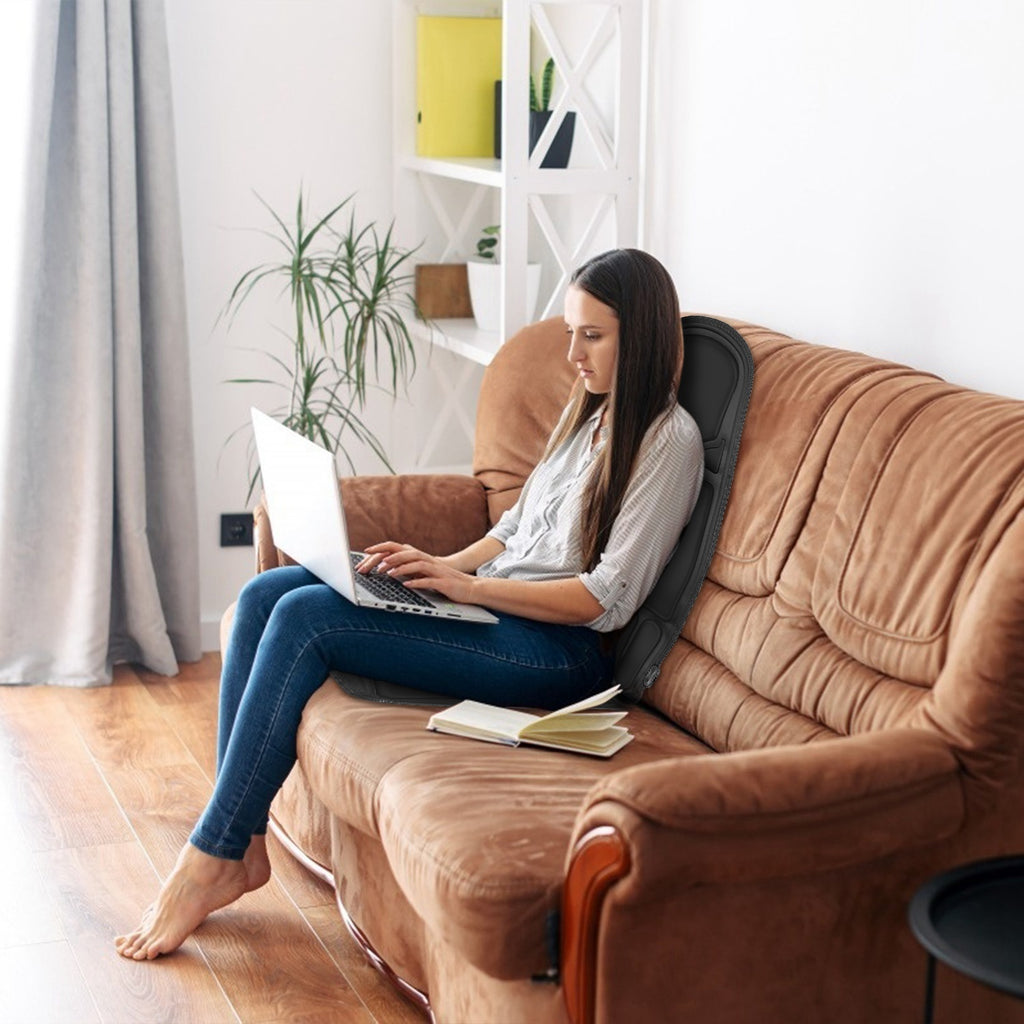 Black seat massage cushion with vibration pads on a sofa backless chair