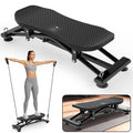 Black sliding ski simulator with resistance bands and foot pedals, used by a person