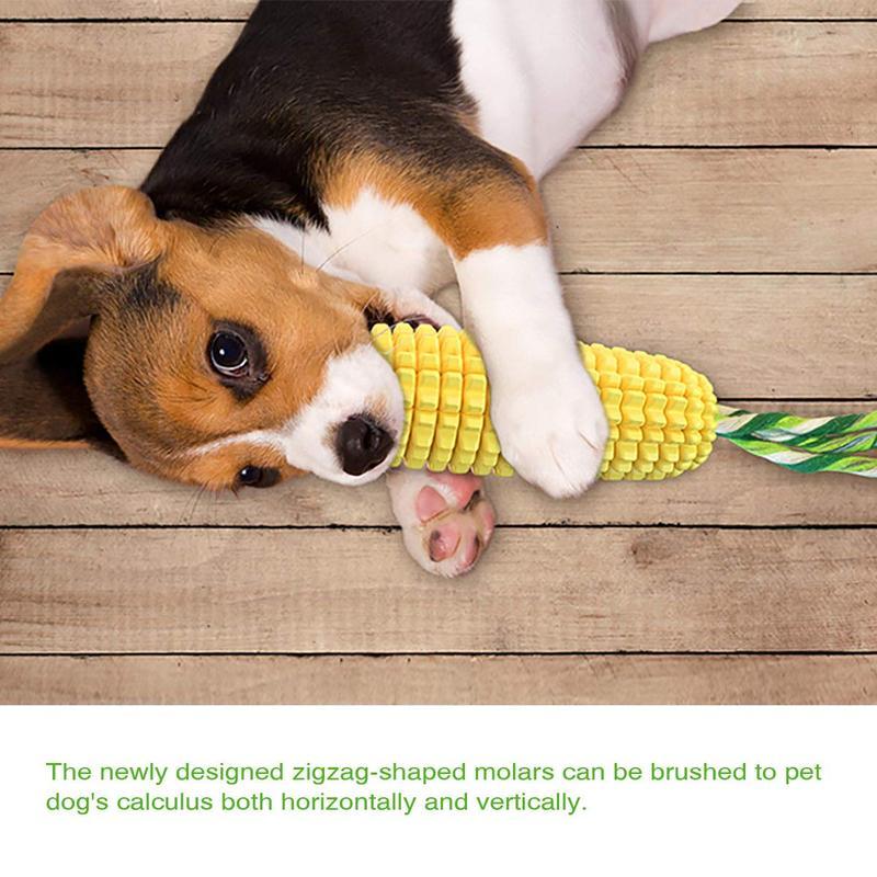 Yellow ridged corn chew toy with green cotton rope tail on wooden floor