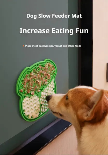 Green slow feeder licking mat with suction cup, held in place while a dog sniffs