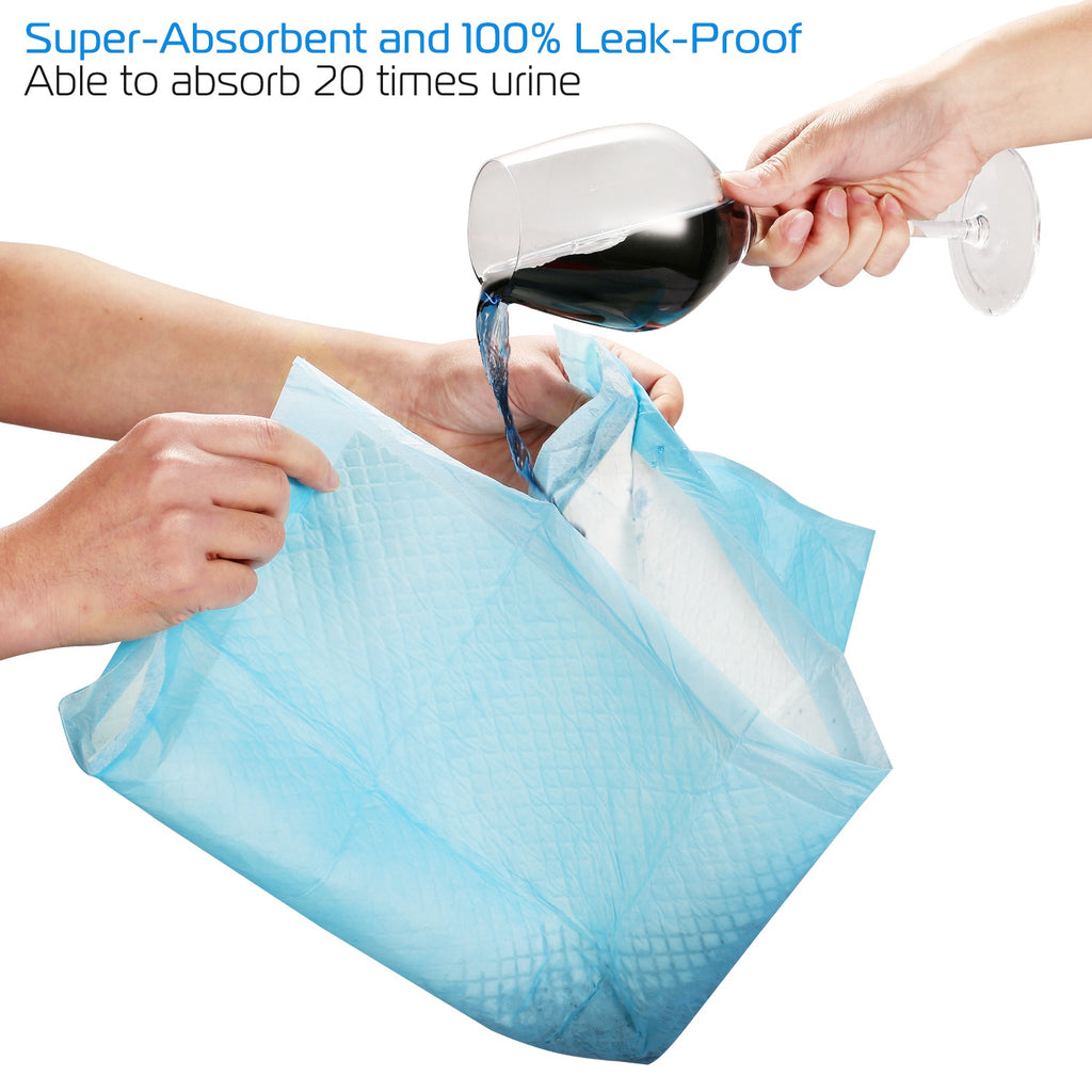 Blue waterproof training pad being held open, with absorbent inner sheet exposed