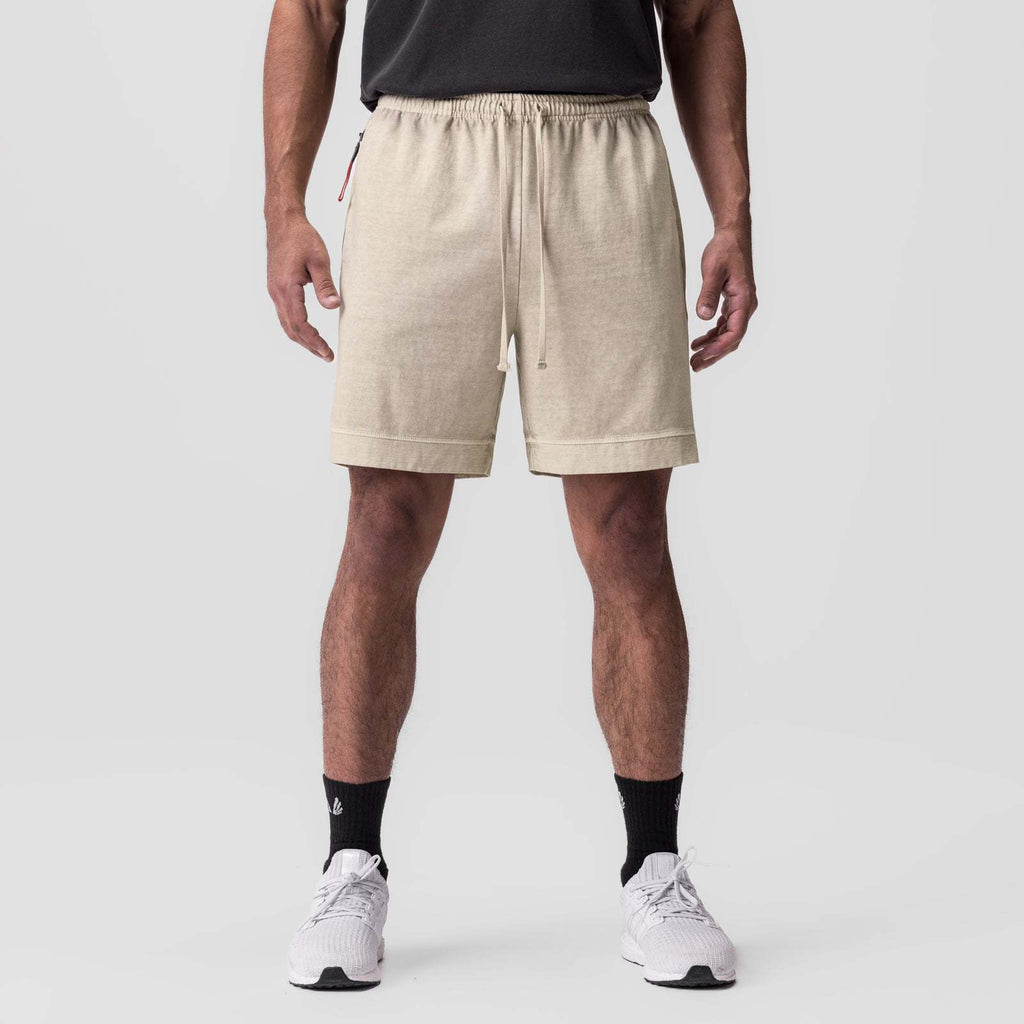 Beige training shorts with elastic waistband and drawstring, side zip pocket detail